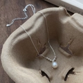 S925 sterling silver necklace with a teardrop freshwater pearl pendant on a minimalist tray - 925 Silver / Silver