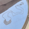 S925 sterling silver tassel necklace with delicate fringe chains on a blue mirror surface - Minimalist Tassel Style / 925 Silver / Silver