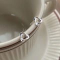 Elegant S999 sterling silver stud earrings with unique clover design on a ceramic cup - Mobius Ring Style (C484)