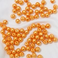 Golden orange faux pearl beads with center hole for DIY jewelry making and necklaces - Orange