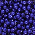 Close-up of dark blue pearlescent round beads with holes for DIY jewelry making - Sapphire Blue