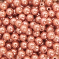 Macro view of salmon pink pearl beads with smooth finish and holes for DIY jewelry - Orange Pink