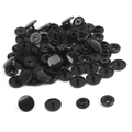 Detailed set of black resin snap buttons showing the four functional components in T5 size - Black