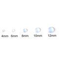 Macro-opname van vijf maten ronde blauwe kattenoog hars cabochons voor DIY-sieraden maken - 4mm (50 Stk./Verpakking) / Wit
