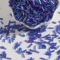 Iridescent dark blue bugle beads for DIY embroidery and jewelry making in white bowl - 15g/Pack (Approx. 300 Pcs) / Sapphire Blue