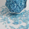 Light blue iridescent glass bugle beads in a ceramic bowl for DIY jewelry making - 15g/Pack (Approx. 300 Pcs) / Lake Blue