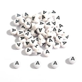 Close-up of round white acrylic alphabet beads with black letter A for DIY jewelry - 100 Pieces/Pack (4x7mm) / Flat Bead A