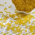 2mm bright yellow transparent glass seed beads in a white bowl for DIY jewelry - Lemon Yellow