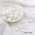 Macro detail of irregular 14x11mm baroque ABS pearls on silk for DIY jewelry making - Long Melon Shape