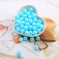 Light blue AB iridescent acrylic round beads in a white heart bowl for DIY jewelry - Lake Blue
