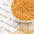 Close-up of frosted amber glass seed beads for DIY jewelry making in a white ceramic dish - 3mm 20g/Pack Approx 700 Pcs / Champagne