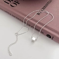 Elegant S925 sterling silver necklace with polished cube pendant on a fashion book - 925 Silver / Silver