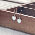 S925 sterling silver heart earrings with iridescent moonstone on a dark wooden display - 925 Silver / White Gold