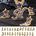 Macro detail of iced-out A-Z alphabet pendants with blue crystals and star bale - Letter A / Silver Star Bail Royal Blue White Rhinestone