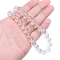 Handheld view of transparent imitation jade glass round beads for DIY jewelry making - 4mm / Clear