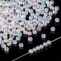 Iridescent AB heart crystal beads for DIY jewelry making on reflective background - Smooth Round Bead Style (2mm) / 50 Pieces/Pack (2mm) / AB Color