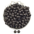 Detailed macro of black acrylic beads with gold pattern in a silver jewelry tray - Wave Pattern Style