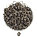 Macro detail of vintage gold acrylic spacers with embossed dots in a silver decorative bowl - Clock Drum Style