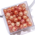 Pink and orange pearlescent glass beads with gold powder marbling in a clear storage box - Approx 20 Beads / Pink Orange Marble
