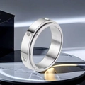 Close-up detail of a silver stainless steel spinner ring featuring sparkling inset stones - Size 6 / Rhinestone Spinning Style (1-C-3) / Steel