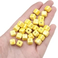 Polished bright yellow cube ceramic beads for DIY jewelry making on human palm - 6mm (10 Pieces/Pack, Hole approx. 2mm) / Yellow