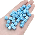 Light blue square ceramic beads for DIY jewelry making held in a palm for scale - 6mm (10 Pieces/Pack, Hole approx. 2mm) / Sky Blue