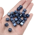 Glossy navy blue square ceramic beads for DIY jewelry making held in a palm - Navy Blue