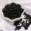 Mix of shiny black faux pearl beads in a ceramic bowl for DIY jewelry and crafts - Diameter 3-8mm Hole Approx 1mm 50g/Bag Approx 750 Pcs / Black