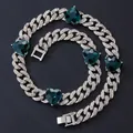 Detailed macro view of silver Cuban chain necklace with emerald green heart shaped gems - 55cm / Silver Necklace