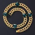 Macro shot of 12mm Cuban link chain with inlaid white zircons and green heart gemstones - 55cm / Gold Necklace