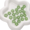 Light green flower-shaped resin beads for DIY jewelry making in a white star-shaped tray - 1 Piece/Pack Diameter approx 16mm Hole approx 4.5mm / Green