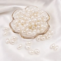 Oval ivory ABS imitation pearls for DIY jewelry making in elegant glass bowl display - Oval Bead / 8x11mm 50 Pieces/Pack / Beige