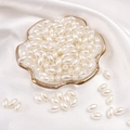 Oval pearlescent beige ABS imitation pearls on a silk tray for DIY jewelry making - Oval Bead / 6x10mm 100 Pieces/Pack / Beige