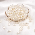 Polished beige oval-shaped faux pearl beads for DIY jewelry making on glass tray - Rice Bead / 6x12mm 100 Pieces/Pack / Beige