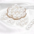 Spherical white faux pearls for DIY jewelry making displayed on a gold-rimmed tray - Round Shape / 16mm 20 Pieces/Pack / White
