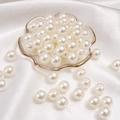 Polished white ABS imitation pearls on elegant glass tray for DIY jewelry making - Round Shape / 12mm (50 Pcs/Pack) / Beige