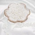 Glossy white round imitation pearl beads for DIY jewelry making on white satin background - Round Shape / 5mm 200 Pieces/Pack / White