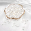 Waterdrop-shaped white pearlescent resin beads in a pink dish for DIY jewelry making - Waterdrop / 6x10mm 100 Pieces/Pack / White