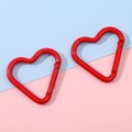 Two bright red heart-shaped alloy carabiners on a pastel pink and blue background - 41x43mm / Red