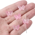 Five pink gradient butterfly beads for DIY jewelry making held in a hand - 20Pcs/Pack / Hot Pink