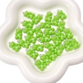 Vibrant green acrylic bear pendants for DIY bracelets in a white floral ceramic tray - 11x21mm / Green