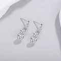 Macro detail of S925 sterling silver drop earrings with three graduated moissanite stones - Punched Moissanite Drop Earrings (E13931)