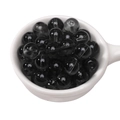 Translucent black glass beads for DIY jewelry making displayed in a white porcelain spoon - 10mm Black (Hole Approx 1.5mm) - 20 Pieces/Pack