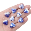 Macro shot of heart-shaped marbled glass beads with horizontal holes for DIY jewelry - 15x15mm (2 Pieces) / Blue and White Marble Pattern Heart