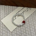 Detail of s925 silver beaded ring with red agate bead and retro lucky coin charm - Silver
