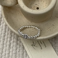 Detailed macro view of S925 sterling silver beaded ring with heart engraved square pendant - Cube Style