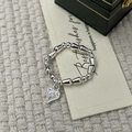Detail view of silver beaded elastic bracelet with heart pendant on a gift card - Heart Style