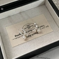 Close-up of French vintage S925 silver cross pearl earrings on a beige jewelry card - 925 Silver / Silver