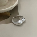Macro detail of a minimalist S925 sterling silver liquid metal irregular open ring - Silver