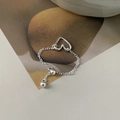 Detailed macro view of 925 silver adjustable chain ring with minimalist heart charm - Silver